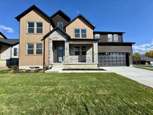 View of front of property featuring a porch, driveway, an attached garage, a front lawn, and stone siding