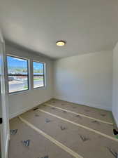 Empty room featuring baseboards
