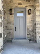 Entrance to property with stone siding