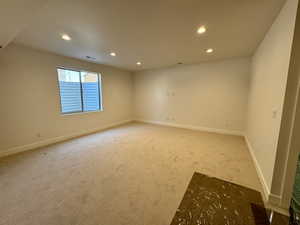 Carpeted empty room with recessed lighting