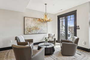 Sitting room featuring a chandelier and wood finished floors