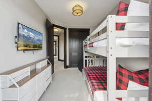 Bedroom featuring light colored carpet