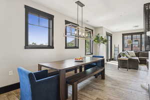 Dining space featuring light wood-style flooring and baseboards