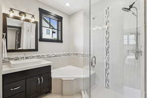 Full bathroom with a garden tub, vanity, a stall shower, tile patterned floors, and recessed lighting