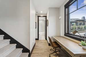 Office with light wood-style floors, plenty of natural light, and recessed lighting