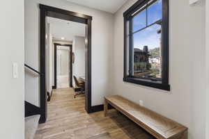 Hall featuring light wood-type flooring, stairway, and recessed lighting