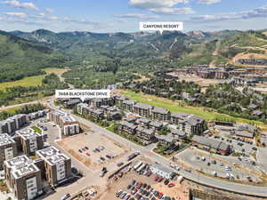 Drone / aerial view of a mountainous background and a golf course