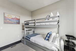 Bedroom with carpet floors and baseboards