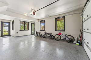 Garage with baseboards and a garage door opener