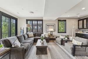 Living area with healthy amount of natural light, recessed lighting, and light wood-style floors