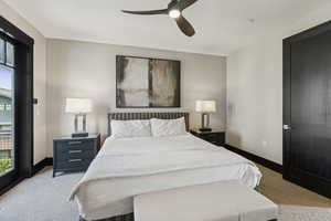 Bedroom with light colored carpet and a ceiling fan