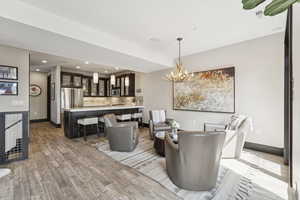 Dining area featuring light wood-style floors, a chandelier, and recessed lighting
