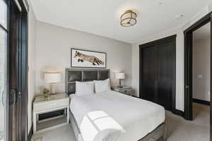 Carpeted bedroom featuring baseboards