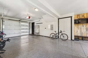 Garage with electric panel and baseboards