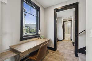 Office space with light wood-style floors and baseboards