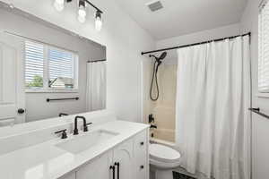Full bath with vanity and shower / bath combo with shower curtain