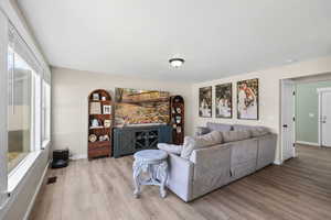 Living area with light wood finished floors and plenty of natural light