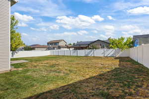 Fenced backyard with a residential view