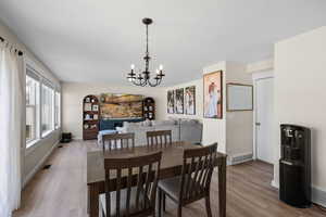 Dining room featuring a chandelier and light wood-style flooring