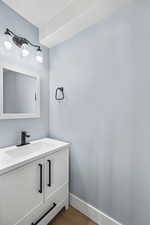 Bathroom with wood finished floors and vanity
