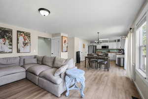 Living area with a chandelier and light wood finished floors