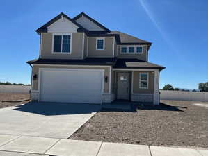View of front of property with a garage, stone siding, driveway, and a porch