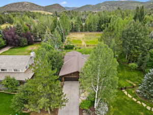 Aerial view of property and surrounding area with mountains