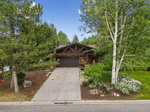 View of front facade with concrete driveway and an attached garage