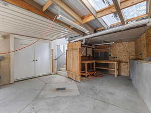 Basement featuring stairs and a workshop area