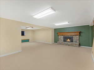 Unfurnished living room with carpet and a stone fireplace