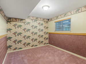 Unfurnished room featuring carpet floors and wallpapered walls
