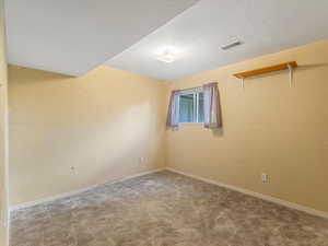 Empty room with carpet and baseboards