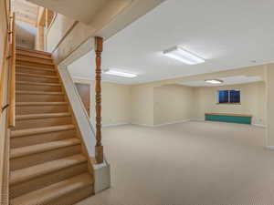 Finished basement with carpet and stairs