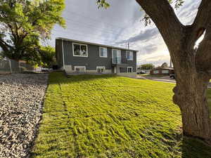 View of front of home with a front lawn and stucco siding