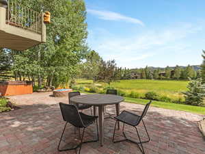 Patio / terrace featuring a hot tub, a patio area, a fire pit, a mountain view, and outdoor dining area