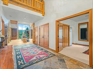 Foyer entrance with arched walkways and stone finish floors