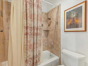 Bathroom with shower / bath combo and toilet