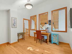 Office with wood finished floors