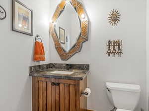 Half bath featuring toilet and vanity