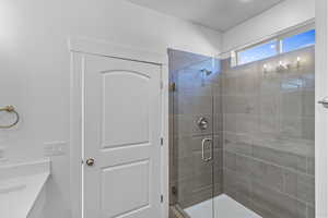 Full bathroom featuring a shower stall and vanity
