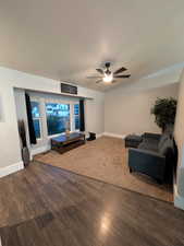 Sitting room with a ceiling fan and wood finished floors