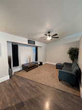 Living room featuring a ceiling fan and wood finished floors