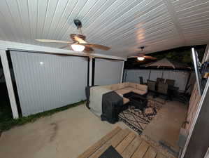 View of patio featuring an outdoor living space with a fire pit and ceiling fan