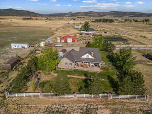 Aerial overview of property's location with rural landscape and a mountainous background