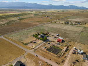 Aerial view of property's location with rural landscape and a mountainous background