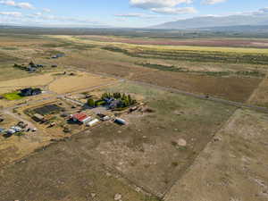 Aerial view of property's location with rural landscape and a mountain backdrop