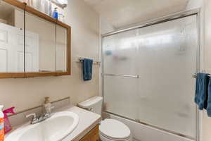 Full bath featuring vanity and enclosed tub / shower combo