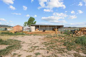 Back of property featuring an outdoor structure