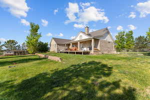 Back of house featuring brick siding and a chimney
