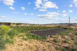 View of yard featuring a view of rural / pastoral area and a mountain view